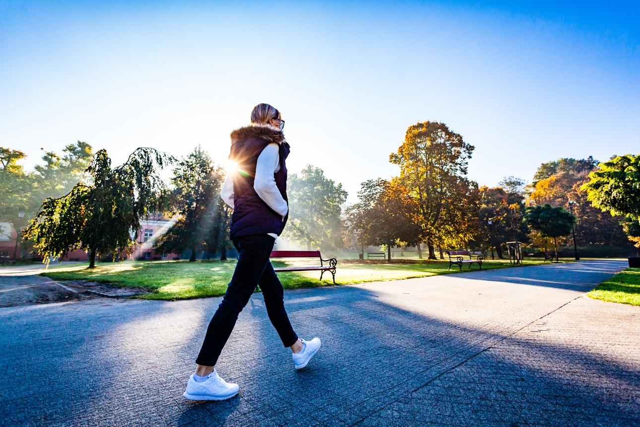 Adult walking outdoors on a neighborhood path