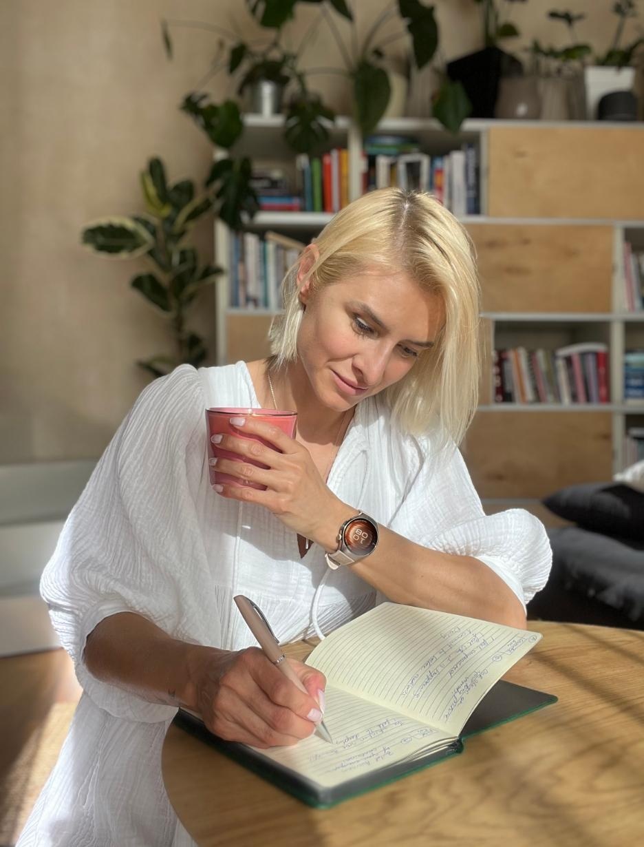 Notebook with wellness metric reference notes and a pen on a desk